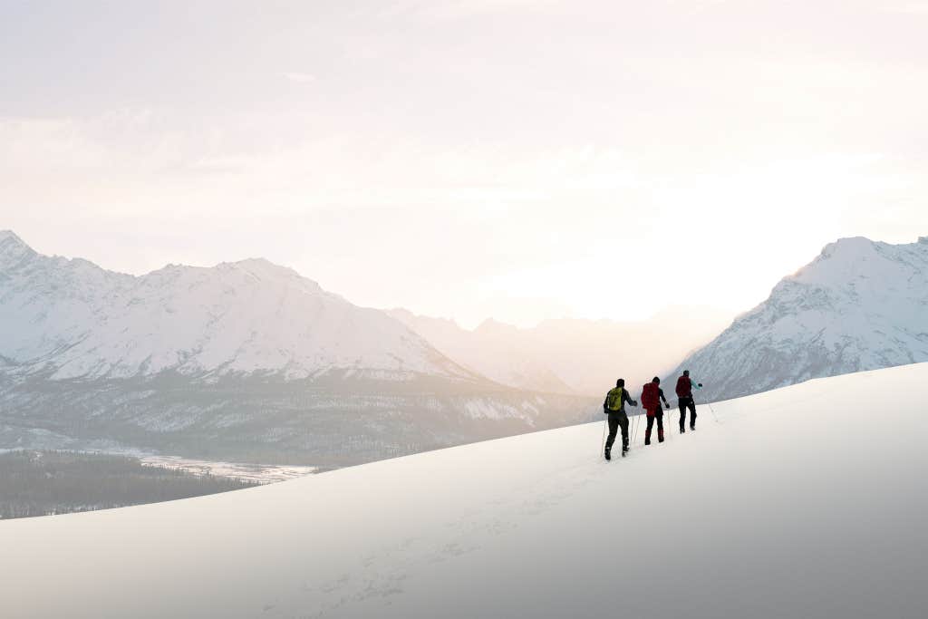 people walking along a hill.